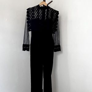 Black lace and sheer jumpsuit, no brand listed.